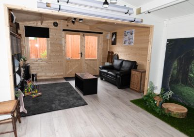 seating area in photography studio with black settee and coffee table