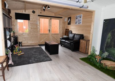 seating area within a photo studio with black settee and coffee table